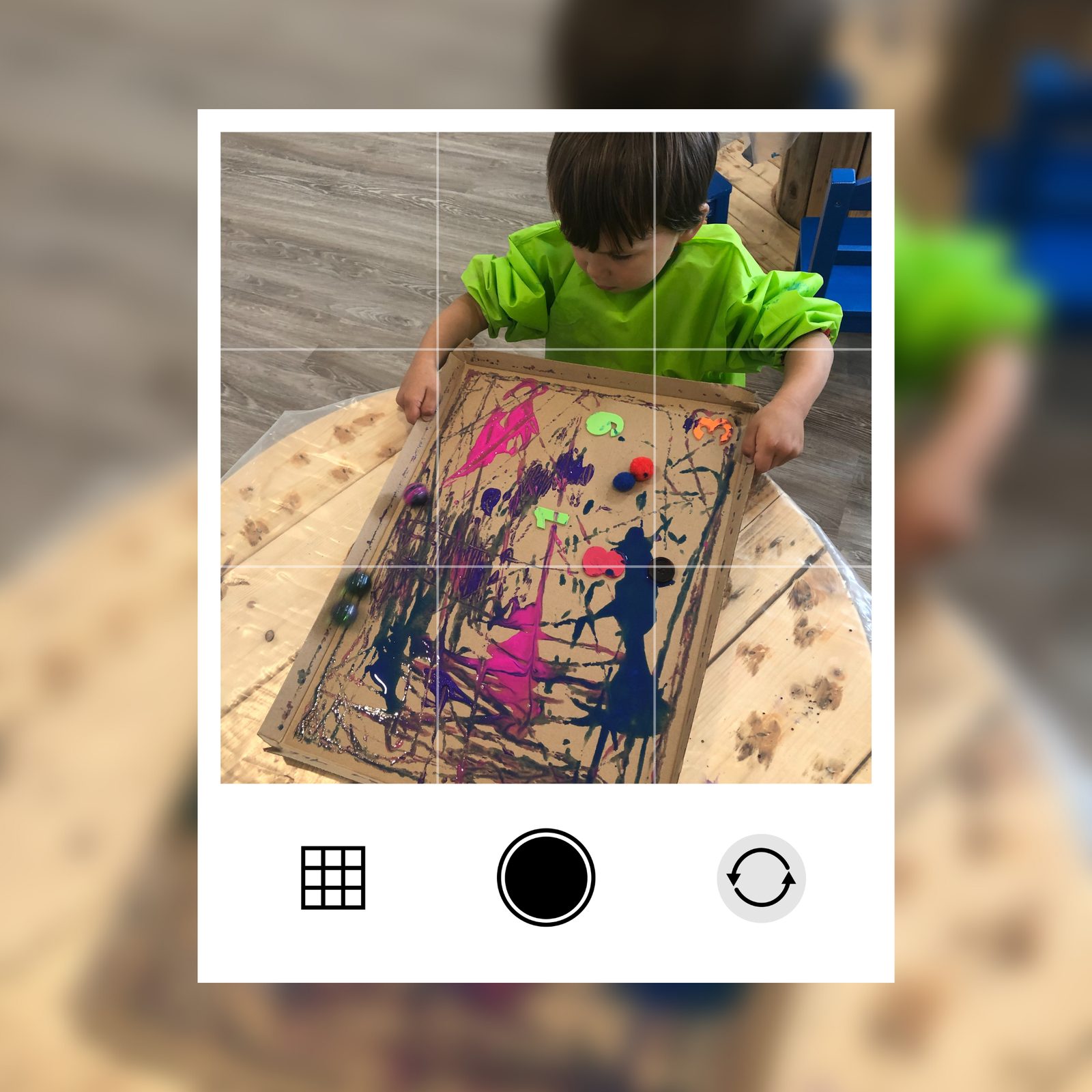 A teacher's app view: photographing a child's marble-painting to share the teachable moment with parents
